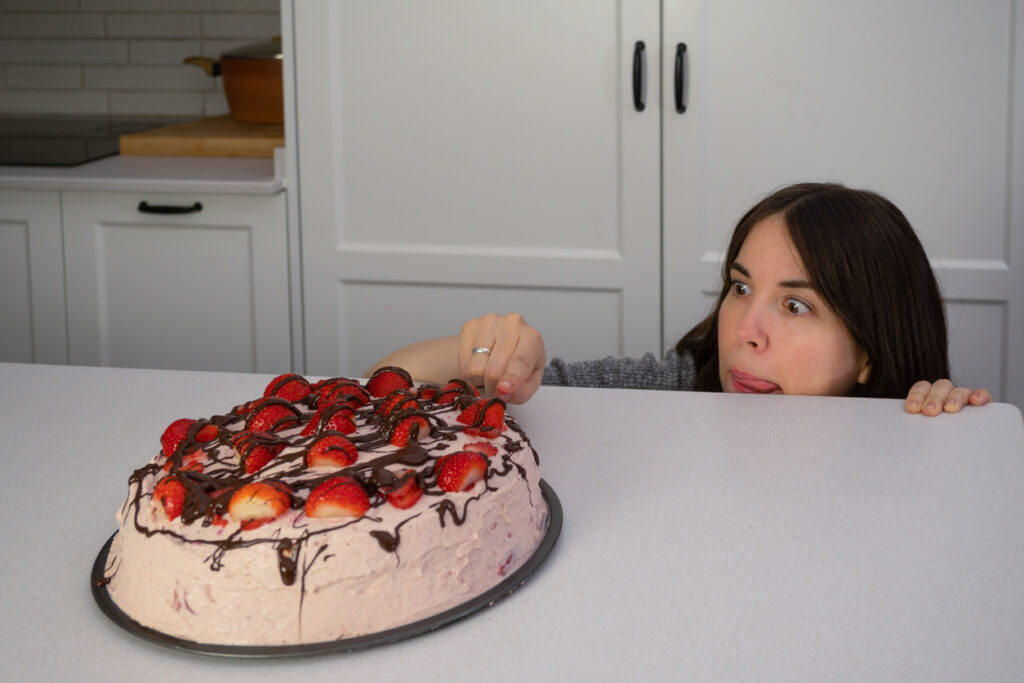 girl eating cake in the kitchen at home